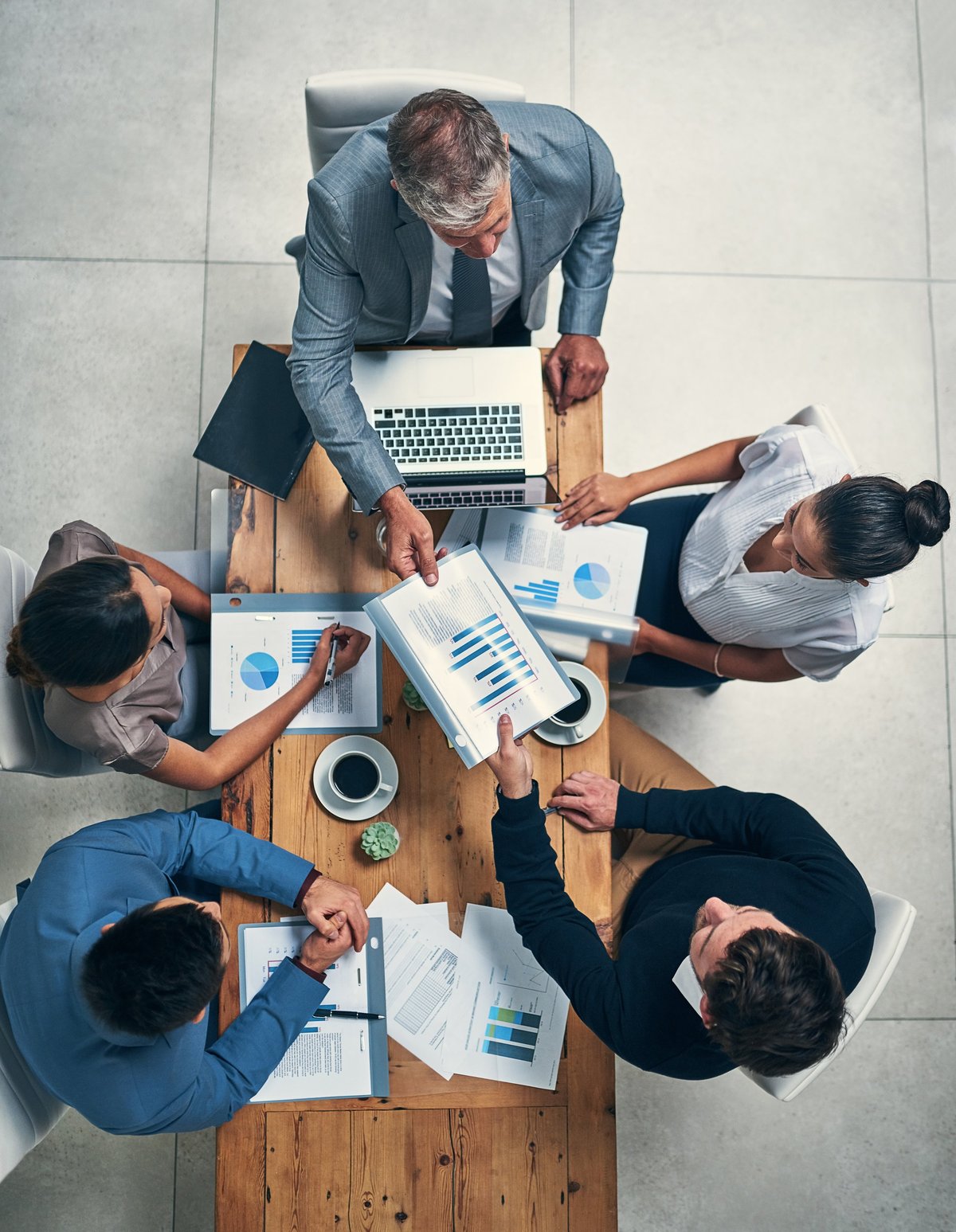 A business team collaborating around a table, focused on the company's growth
